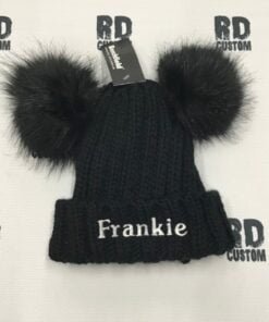 black pom pom with white writing