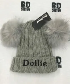 grey pom pom with black writing